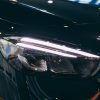 Close-up of Mercedes car headlight with protective PPF film installation.